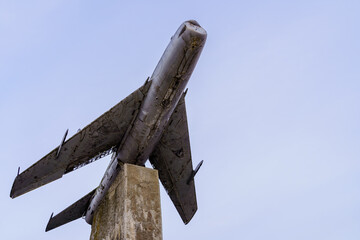 Monument to an old retro vintage airplane. Background with copy space