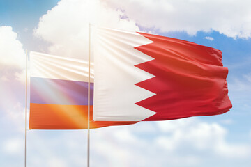 Fototapeta na wymiar Sunny blue sky and flags of bahrain and russia