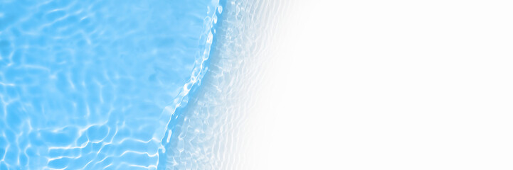 Surface of blue swimming pool water with light reflection and waves. Texture of transparent blue water with waves in swimming pool. Trendy long abstract banner with white copy space