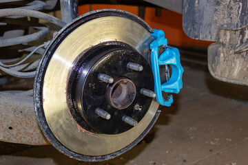 Vehicle disc brake for repair, in the process of replacing new tires. Repair of car brakes in the...