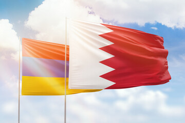 Sunny blue sky and flags of bahrain and armenia