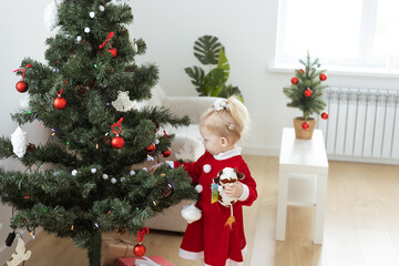 Toddler child with cochlear implant decorating christmas tree - deafness and diversity and...