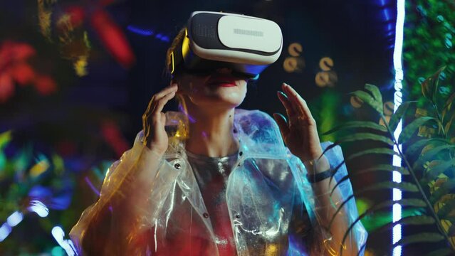 happy modern 40 years old woman in metaverse in vr goggles exploring.