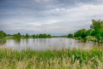 Perfect lake in the summer season with cloudy sky