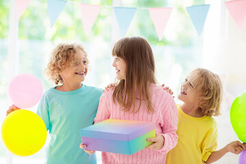 Kids birthday party. Child blowing out cake candle
