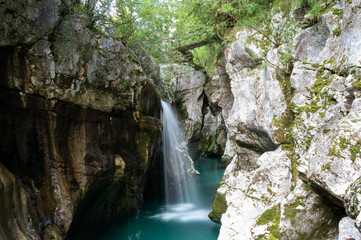 Fototapeta na wymiar Long exposure image of a waterfall on emerald Soca river