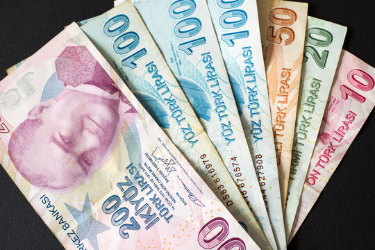 Turkish coins (200-100 -50-20-10 Turkish Lira) stacked on black background, top view