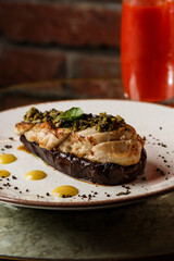 Baked eggplant stuffed with grilled chicken, tomatoes and spices on white plate. Traditional dish Karniyarik of turkish cuisine. View from above