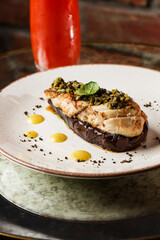 Baked eggplant stuffed with grilled chicken, tomatoes and spices on white plate. Traditional dish Karniyarik of turkish cuisine. View from above