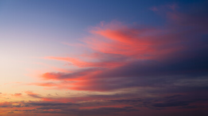 Sky with clouds during sunset. Pink clouds and blue sky. A high-resolution photograph. Panoramic photo for design and background.