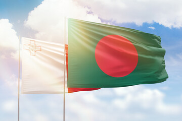 Sunny blue sky and flags of bangladesh and malta