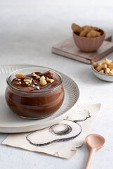 Avocado chocolate pudding, glass dessert on the light background