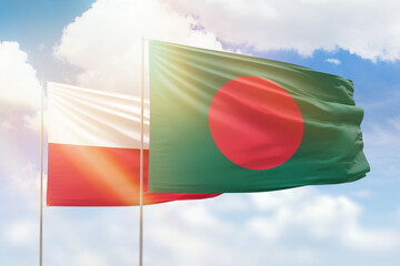 Sunny blue sky and flags of bangladesh and poland