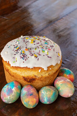 Easter cake with multicolored Easter eggs. Bright packaging. Preparations for Easter. Festive cakes with white glaze