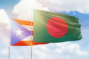 Sunny blue sky and flags of bangladesh and puerto rico