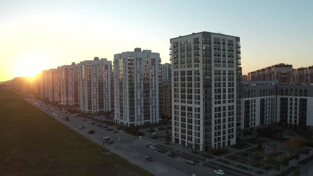 Top view of residential area with high-rise buildings at dawn. Stock footage. Picturesque view of complex residential area with sunrise sun. Panorama of residential complexes on background of dawn