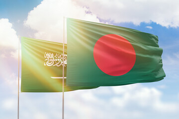 Sunny blue sky and flags of bangladesh and saudi arabia