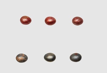 Easter chicken eggs, painted for the holiday with red and dark paint, lie in two even rows on a white background, forming a frame for the image.