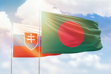 Sunny blue sky and flags of bangladesh and slovakia