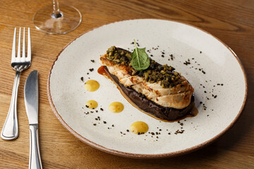 Baked eggplant stuffed with grilled chicken, tomatoes and spices on white plate. Traditional dish Karniyarik of turkish cuisine. View from above
