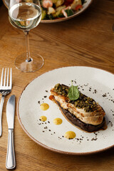 Baked eggplant stuffed with grilled chicken, tomatoes and spices on white plate. Traditional dish Karniyarik of turkish cuisine. View from above