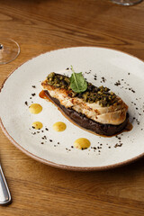 Baked eggplant stuffed with grilled chicken, tomatoes and spices on white plate. Traditional dish Karniyarik of turkish cuisine. View from above