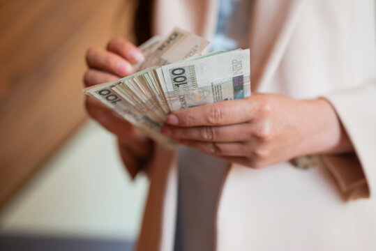 a girl holds banknotes money polish zloty in her hands for payment
