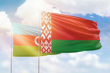 Sunny blue sky and flags of belarus and azerbaijan