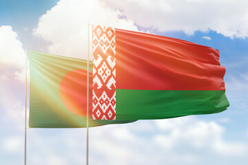 Sunny blue sky and flags of belarus and bangladesh