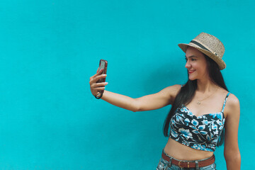 girl taking photo with blue background