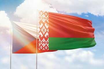 Sunny blue sky and flags of belarus and czechia
