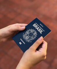 Hands holding Brazilian passport.