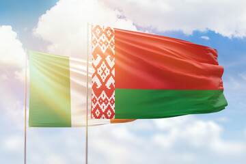 Sunny blue sky and flags of belarus and ireland