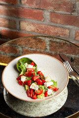 Tasty and healthy salad with arugula, brie cheese, avocado, cherry tomatoes and strawberry. Top view. The flat lay. Banner