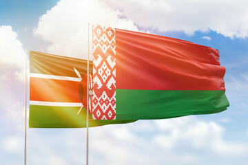 Sunny blue sky and flags of belarus and kenya