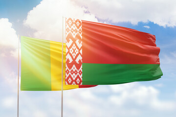 Sunny blue sky and flags of belarus and mali