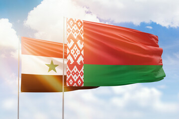 Sunny blue sky and flags of belarus and syria