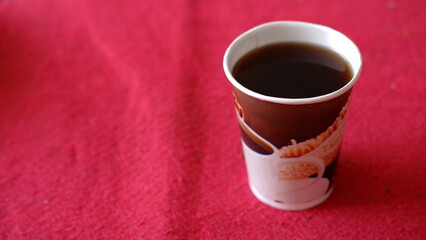 A cup of coffee on red background 