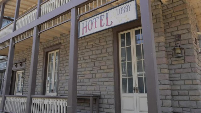 This panning video shows an old western hotel front facade building.