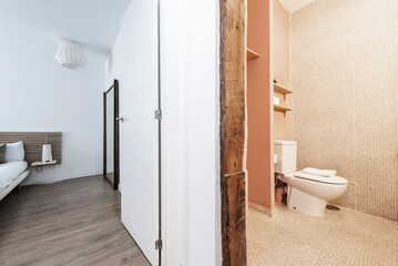 Fototapeta na wymiar Vacation rental apartment with renovated bathroom with vintage wooden beams, double bed and wall mirror