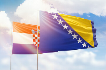 Sunny blue sky and flags of bosnia and croatia