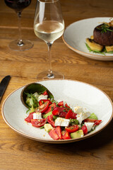 Tasty and healthy salad with arugula, brie cheese, avocado, cherry tomatoes and strawberry. Top view. The flat lay. Banner
