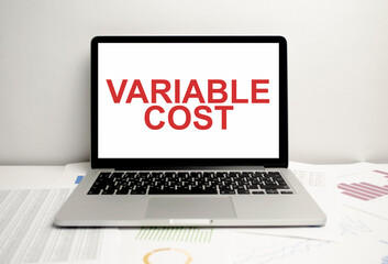 variable cost words on display laptop and charts
