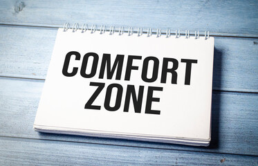 comfort zone words on notebook on wooden background