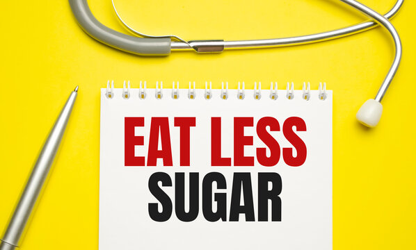 eat less sugar words on notebook and stethoscope on yellow background