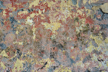 A flaking painted wall that resembles an abstract painting