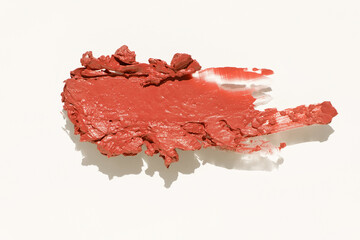 Cosmetics lipstick swatches. Peach, beige, red and coral toned styled cosmetics flat lay. Closeup colour palette. Creative concept photo of cosmetics samples isolated on white background