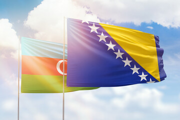 Sunny blue sky and flags of bosnia and azerbaijan