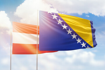Sunny blue sky and flags of bosnia and austria