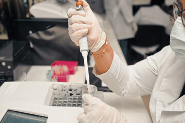 Latina operator filling medical samples with laboratory equipment in a hospital
